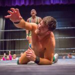 wrestler on the ring floor begging for mercy
