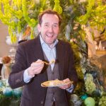 Actor ben miller eating cake at a christmas party at Anyhoe