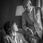 Fine art moment of groom with his dad before the wedding