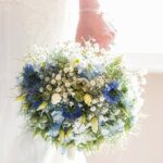 close up of a brightly lit bouquet in brides hand