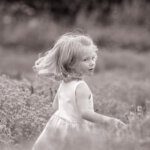 Young blonde girl running in  lavender field looking back