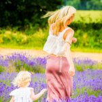 Muma nd todder running through a lavender field from behind