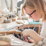 female jeweller working at her bench