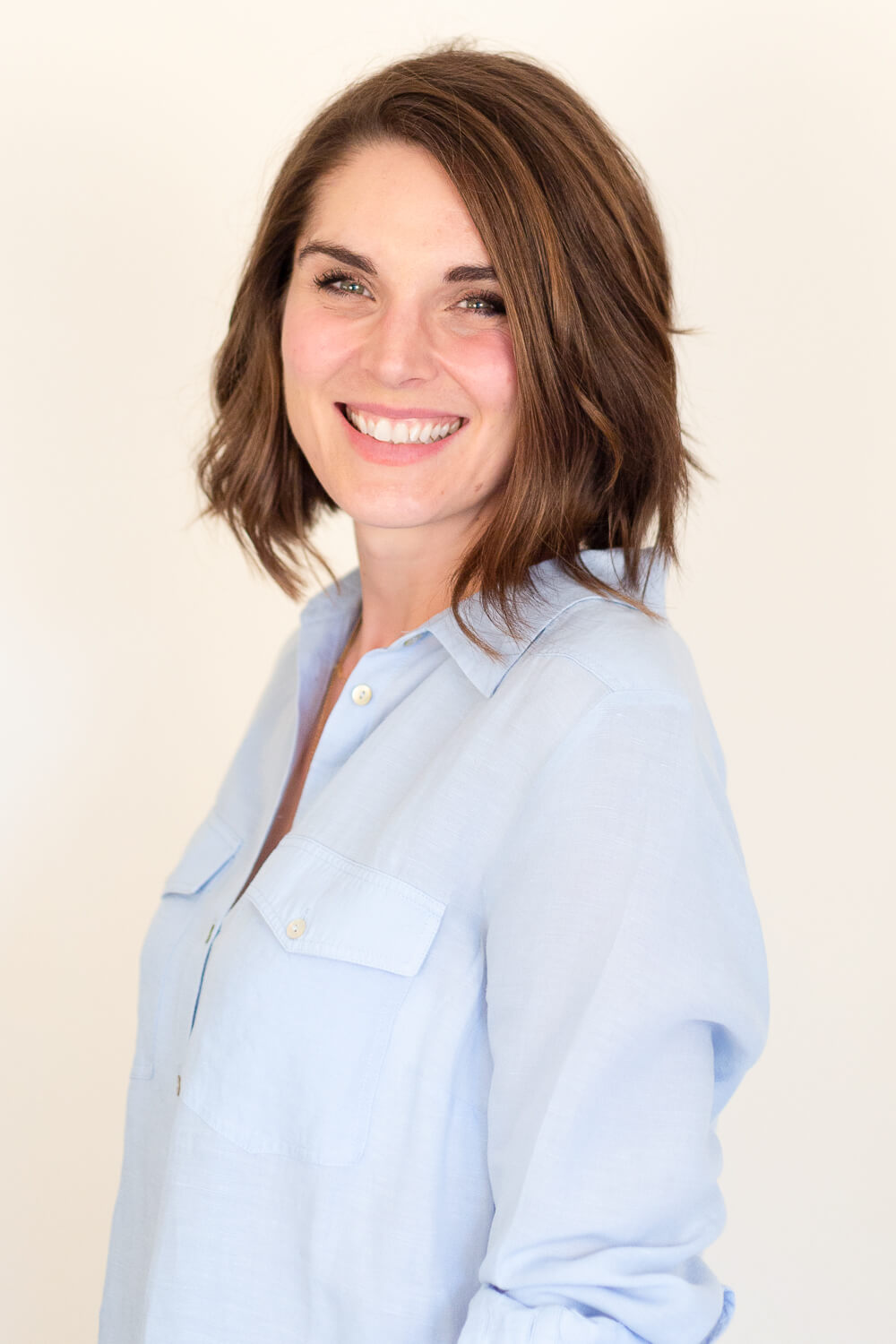 Smiling lady in pale blue shirt