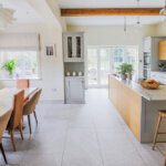 interior of a bright marble and wood kitchen island and dining table