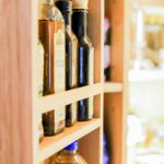 close up of jars of oil in a pantry door shelf