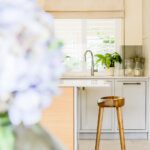 Kitchen breakfast bar with wooden stool and flowers