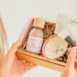 model holding an open box  of beauty products