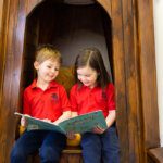 Two children reading in a tree library